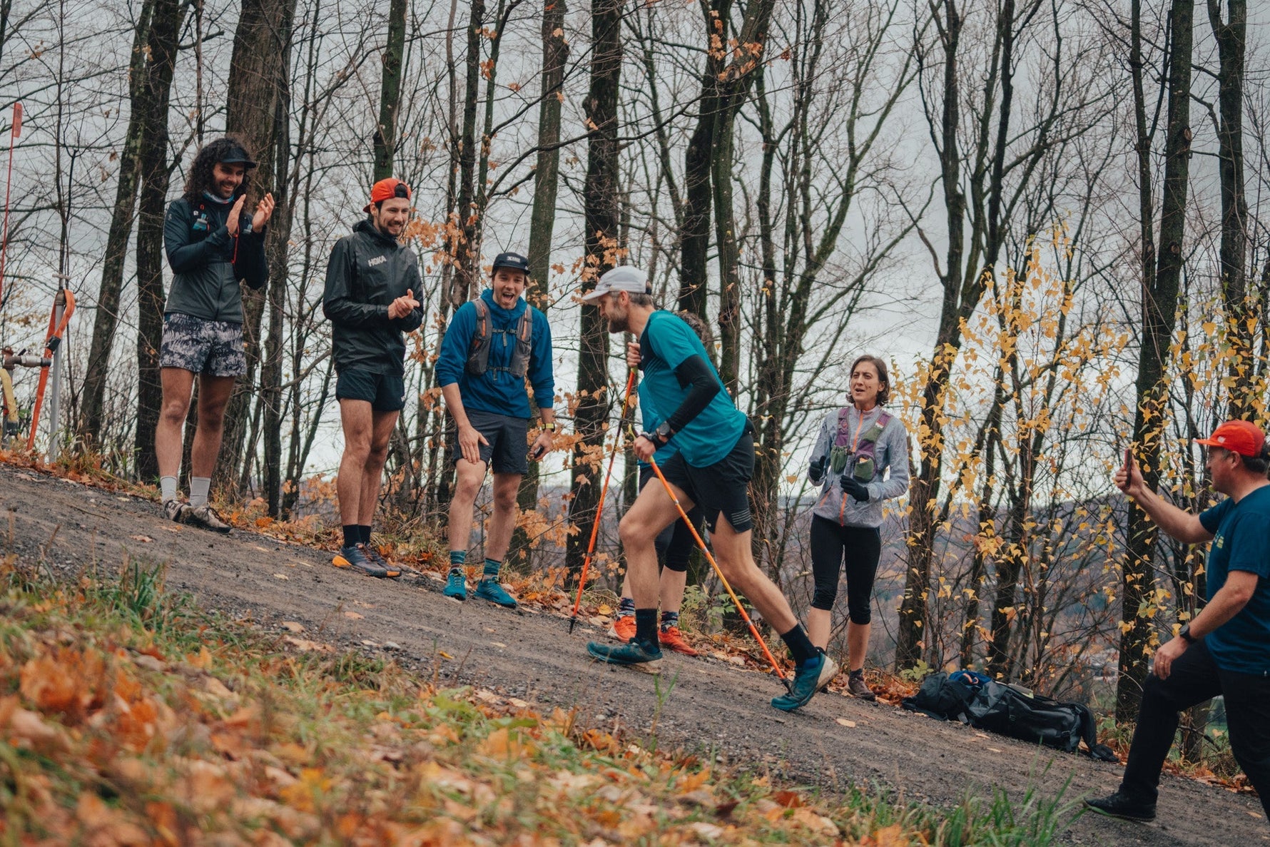 Alister Gardner running up Mont Bromont during an Everesting challnege accompanied by some cheering friends